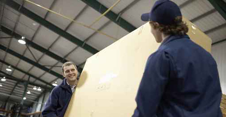 Warehouse staff carrying a box